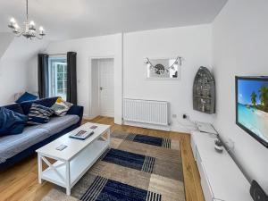 a living room with a couch and a table at Beachside Cottage Minehead in Minehead