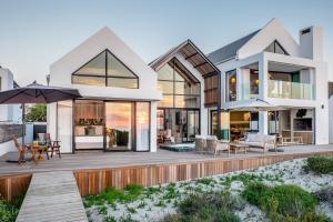 an image of a house with a deck at Thalassophile Beach House in St Helena Bay