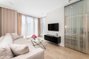 Televízia a/alebo spoločenská miestnosť v ubytovaní Ga Luxury Apartments M54