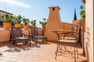 a patio with chairs and a table on a balcony at Yartan Boutique Hotel - Adults Only in Art&aacute;