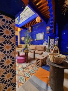 a living room with blue walls and a couch at Casa Amina in Chefchaouene