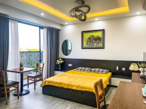 a bedroom with a bed and a dining room at Green Line Long Bien - Serviced Apartment - Ngoc Thuy - Hanoi in Hanoi