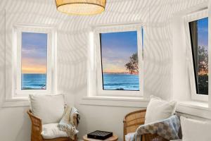 a room with two chairs and two windows at Beachside Boho Retreat by Sydney Dreams in Sydney