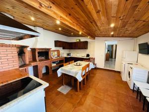 a kitchen with a table and a dining room at Soares Village II in Amoreira