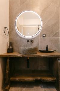 a bathroom with a sink and a mirror at Naxian Harmony Town Suites in Naxos Chora +40 photos