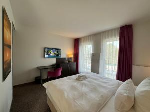 Postel nebo postele na pokoji v ubytování Fontane Hotel