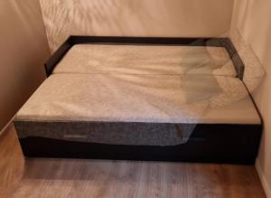 a small bed in a corner of a room at Chambres d'hôtes Les Marmottes in Arbéost
