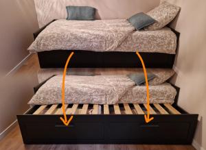 two beds in a room with diagrams of their dimensions at Chambres d'hôtes Les Marmottes in Arbéost