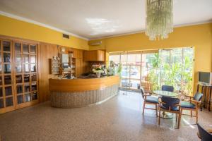 a kitchen with a counter and a table and chairs at Albergo Ristorante Edo in Forlimpopoli