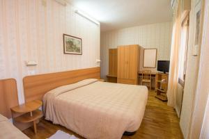 a hotel room with a bed and a television at Albergo Ristorante Edo in Forlimpopoli