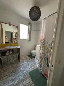 a bathroom with a sink and a toilet and a mirror at LA BELLE ETAPE in Capestang