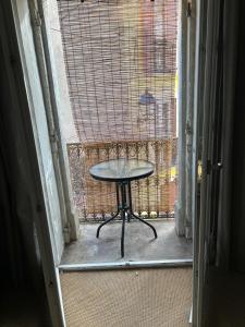 a table in the doorway of a room with a window at LA BELLE ETAPE in Capestang