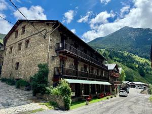 a building with balconies on the side of a street at Hotel Valls Valira in Os de Civís
