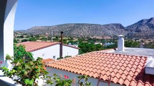 a view of a roof with mountains in the background at Sounio Poseidon Villa in Sounio