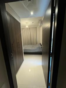 a hallway leading to a bedroom with a bed at Victoria home in Dubai