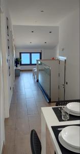 a large room with a table and chairs and a floor at BURELA Mariña PLAYA in Burela de Cabo