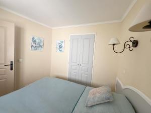 a bedroom with a blue bed and a white door at AZUR APPARTEMENT (SEA VIEW) LES RESTANQUES DE ST-TROPEZ1131 in Grimaud +23 photos