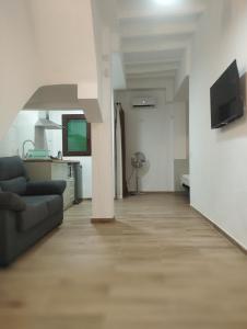 a living room with a couch and a television at FORUM EXPERIENCE Adults Only in Tarragona