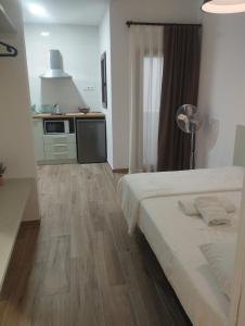 a bedroom with a bed and a kitchen with a floor at FORUM EXPERIENCE Adults Only in Tarragona +14 photos