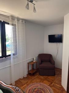 a living room with a chair and a window at Jasna in Poreč