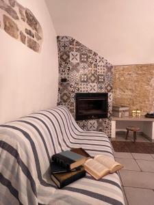a bed with books on it with a fireplace at La Cantina Guest House in Bisceglie