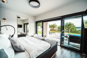 a bedroom with a large bed and a large window at Villa Kara Sevda in Ražanac +33 photos
