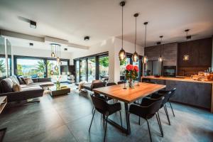 a kitchen and living room with a wooden table and chairs at Villa Kara Sevda in Ražanac