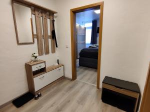 a room with a mirror and a bed in a room at Wohlfühl-Wohnungen im Herzen von Clausthal in Clausthal-Zellerfeld