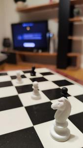 a chessboard with two white chess pieces on it at Calipsso Apartment's in Belogradchik