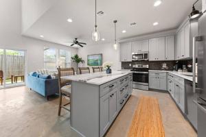 eine große Küche mit weißen Schränken und einer blauen Couch in der Unterkunft Cajun French House-2 King Beds-Near Sports Complex in Lafayette