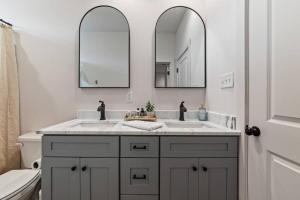 ein Badezimmer mit zwei Waschbecken und zwei Spiegeln in der Unterkunft Cajun French House-2 King Beds-Near Sports Complex in Lafayette + 22 Fotos