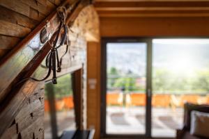 a pair of glasses hanging on a brick wall with a window at Chalet La Souris, chaleureux avec vue panoramique in Gérardmer