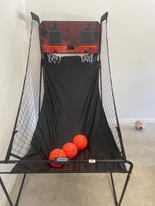 a basketball hoop with balls inside of it at 5 Minutes to Rye beach in Rye