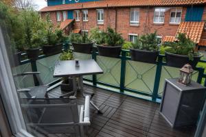 a balcony with a table and chairs and a television at A-Apartment Wolfsburg in Wolfsburg