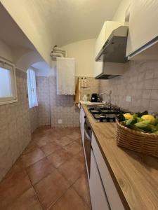 a kitchen with a counter with a sink and a stove at Casa Ami in Bordighera +16 photos