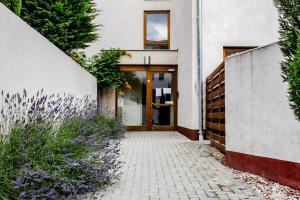 a door to a building with purple flowers at Six Corners Garden Corner with Terrace and Parking in Pécs
