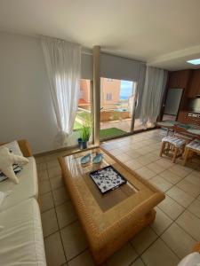 a living room with a couch and a table at Esquinzo Playa 3 Jandia Fuerteventura in Playa Jandia