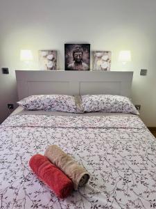 a bedroom with a bed with a red towel on it at Yudelmys confort in Las Palmas de Gran Canaria