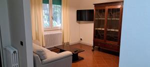 a living room with a couch and a chair at Domus Le Palme in Fano