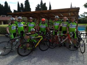 a group of people posing for a picture with their bikes at Hotel Adria & Resort in Toscolano Maderno