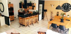 a kitchen with a bar and a table and chairs at Villa CLOTESS in Dompierre-sur-Mer