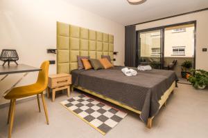 a bedroom with a large bed and a desk at Marina Beach 38 Denia in Denia
