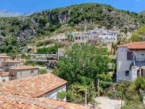 a view of a village with houses and a mountain at Cozy Apartment in Drymades Village in Dhërmi