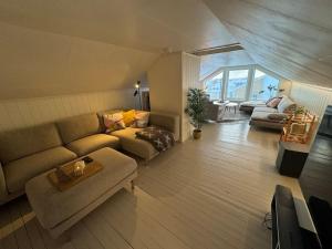 a living room with a couch and a table at Agaton Apartment in Andenes