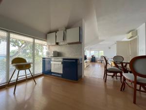 a kitchen with blue cabinets and a table and chairs at TerraMar.Apart in Balchik