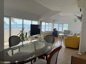 a living room with a glass table and chairs at TerraMar.Apart in Balchik