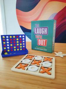 a board game and a book on a table at Sun and Sand Focene in Focene