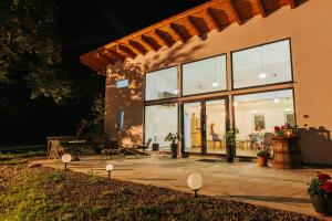 a house with large glass windows and a patio at ReziPava Camping in Zăbala