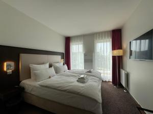 Postel nebo postele na pokoji v ubytování Fontane Hotel