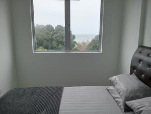 a white room with a bed and a window at EM Camar Seaview Homestay at Sutra Villa2 in Kuantan +2 photos